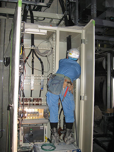 High-voltage cable connection in an electrical room representing the charged atmosphere of an earnings call
